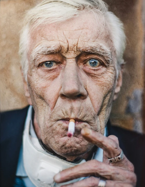 an old man smoking a cigarette with a suit and tie