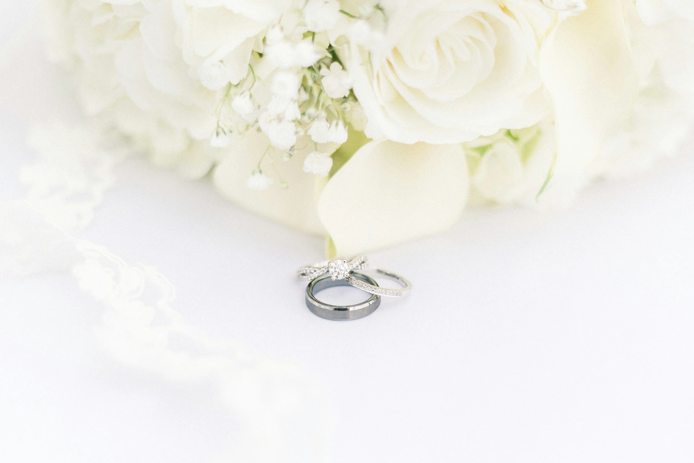 a bouquet of flowers with wedding rings on it