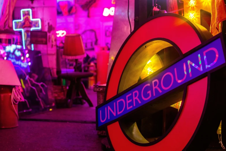 a underground tube sign with colorful lights around it