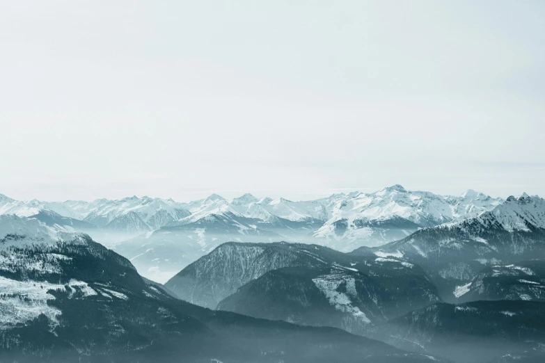 a black and white po of mountains covered with snow