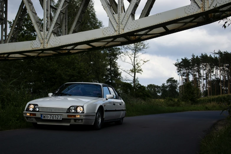 the car has parked near a large bridge