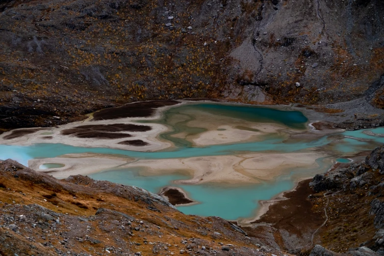 two blue lakes surrounded by rocky mountains