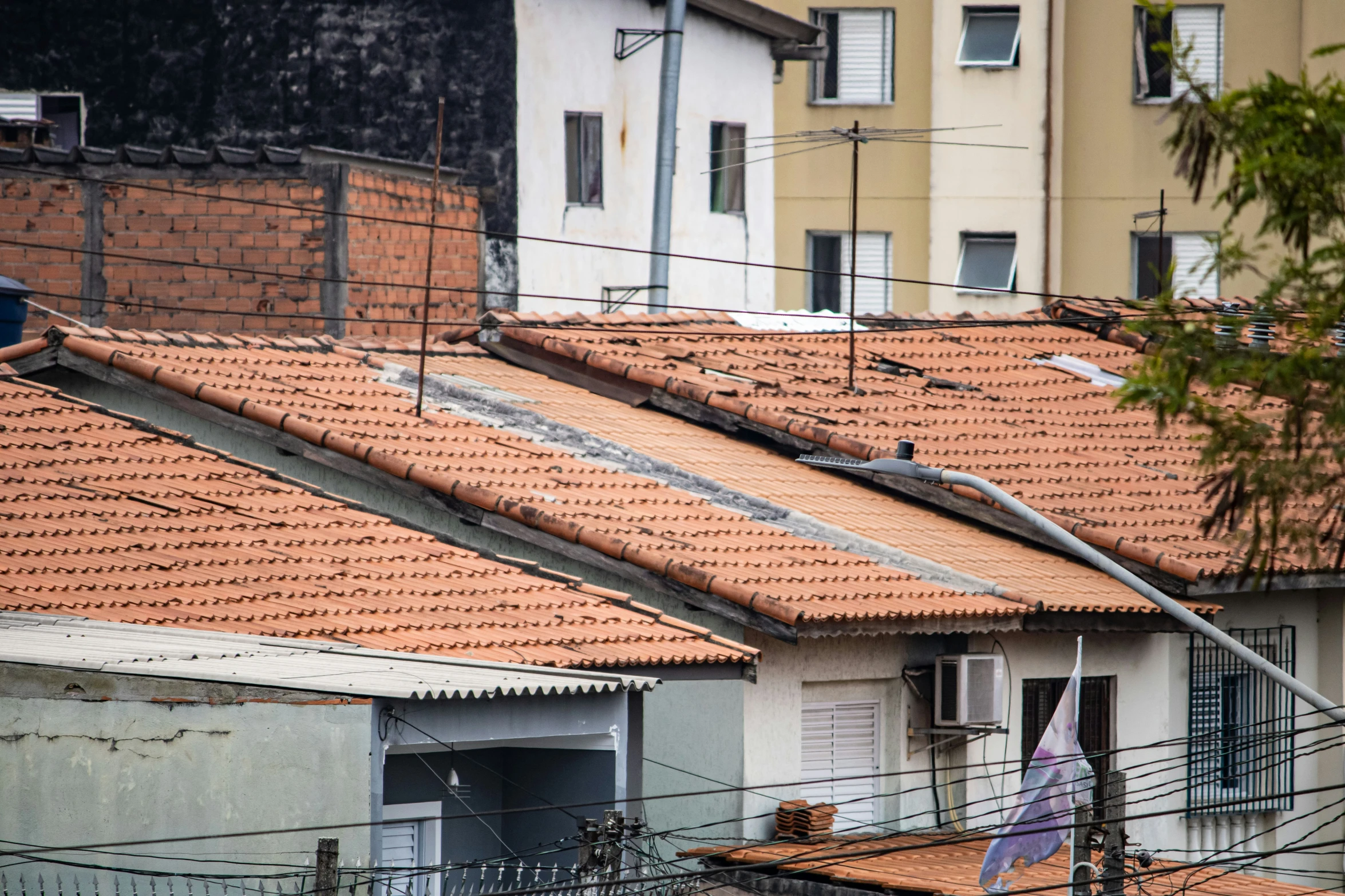 the roofs of several buildings are tiled with red tiles