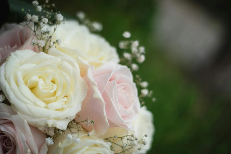 a bouquet of white and pink flowers sitting on a table