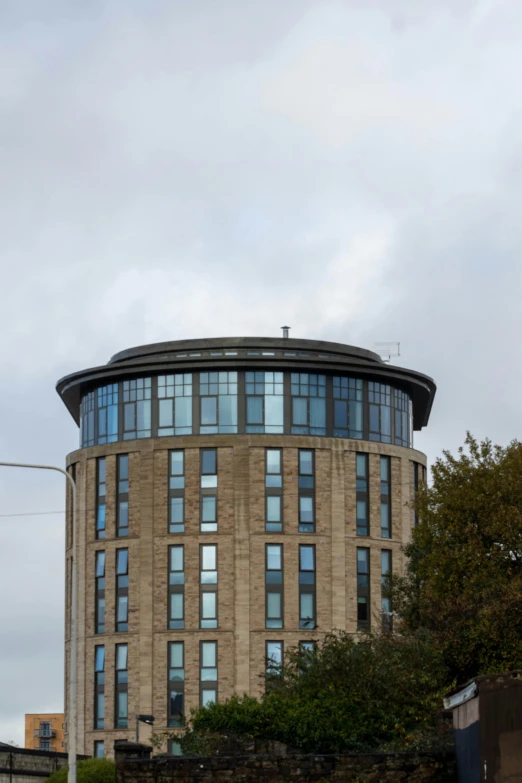 a brown building is next to a wall