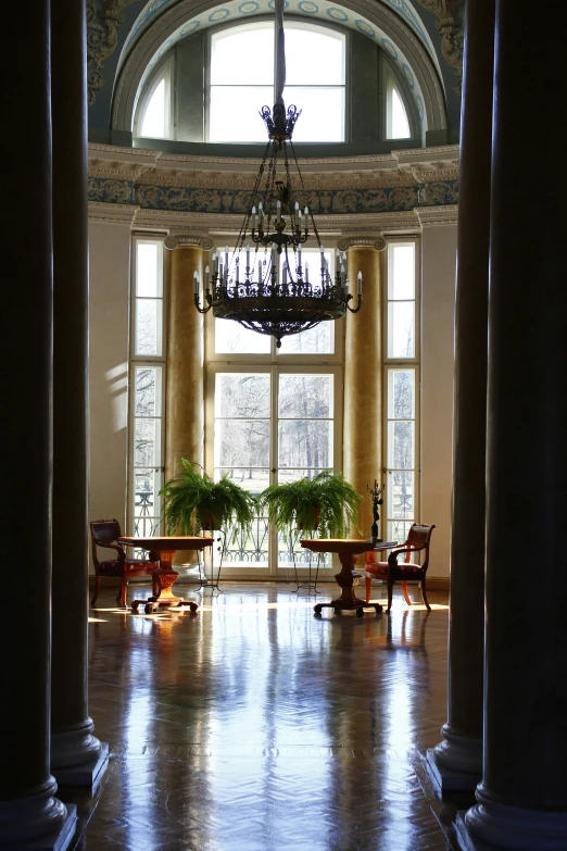 the inside of a building with many windows and chairs