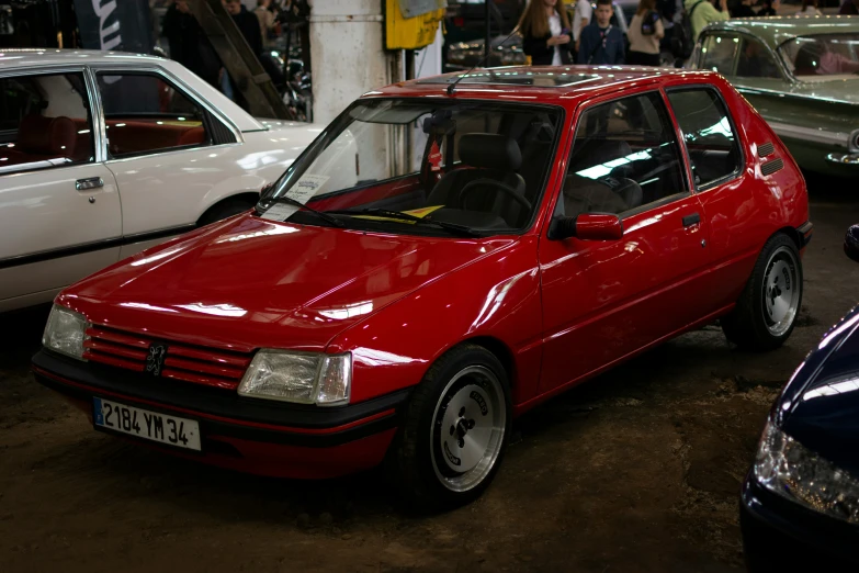 several small red and white cars parked in a parking lot