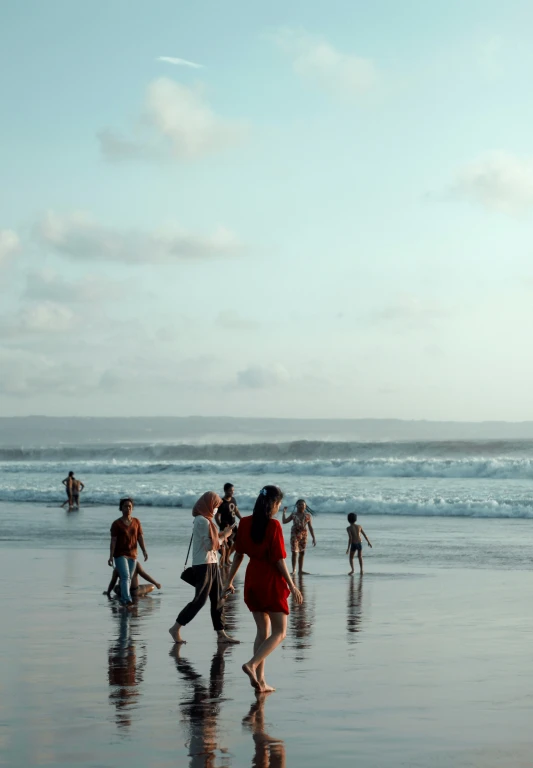 several people are running along the beach with surfboards