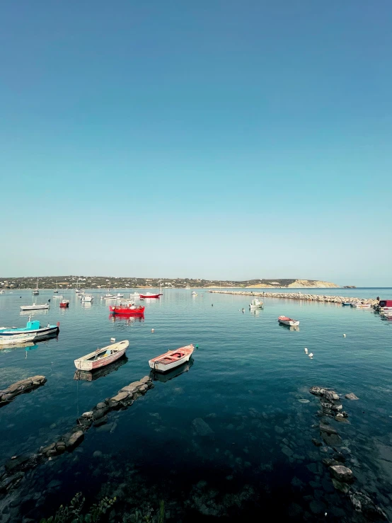 boats are in the ocean on an early afternoon