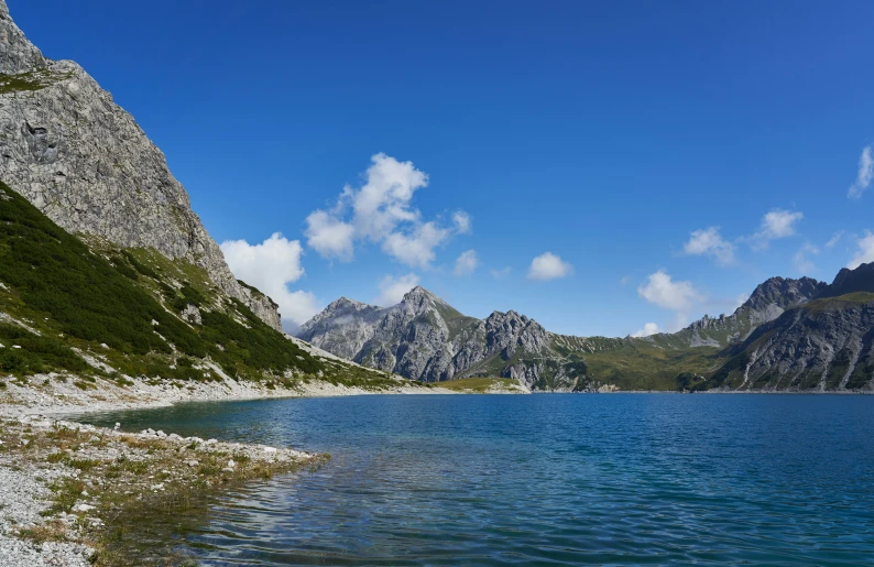 two mountains surrounding a body of water with trees in it