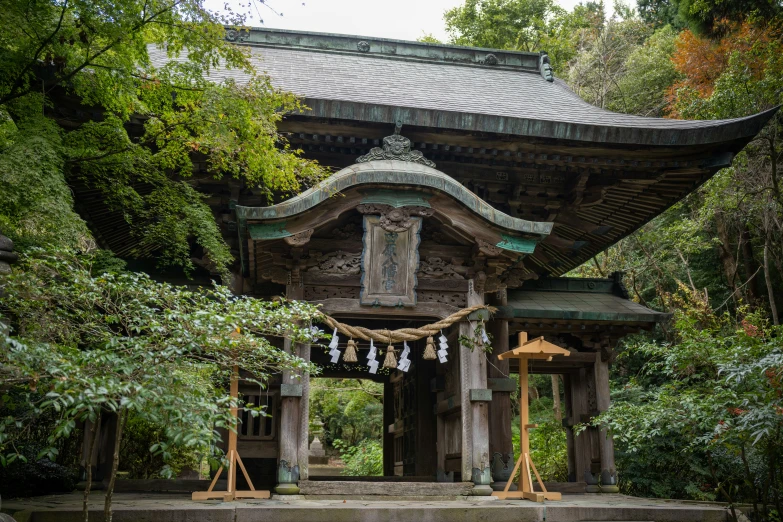 an asian building is located among the trees