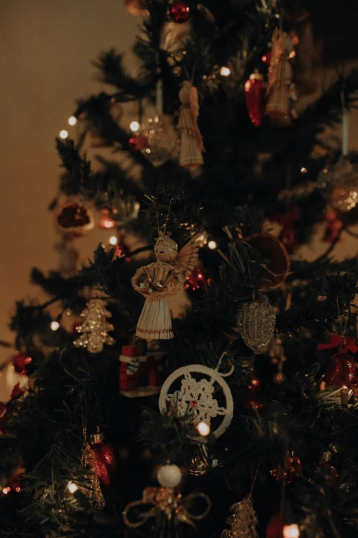 a christmas tree is shown with ornaments on top