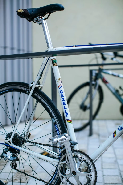 there is a silver bike sitting against a pole