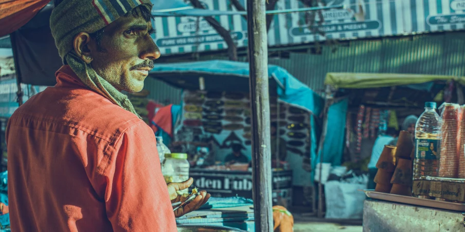 a man in red shirt next to a store