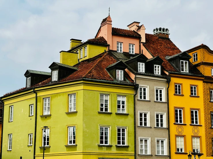 a view of many multicolored buildings with some white windows