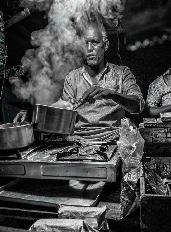 two men sitting at a table covered in food