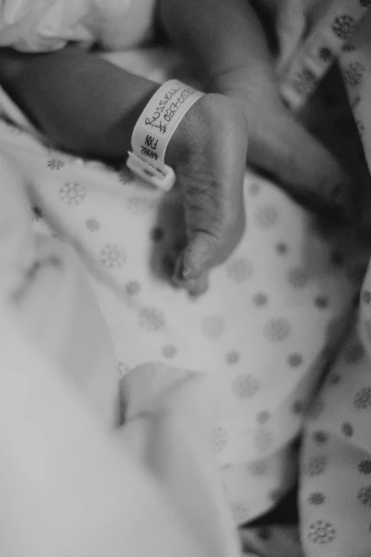 a black and white image of a baby in the crib