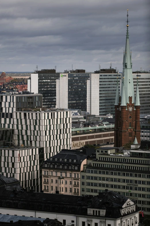 the city skyline with buildings and clouds in the background