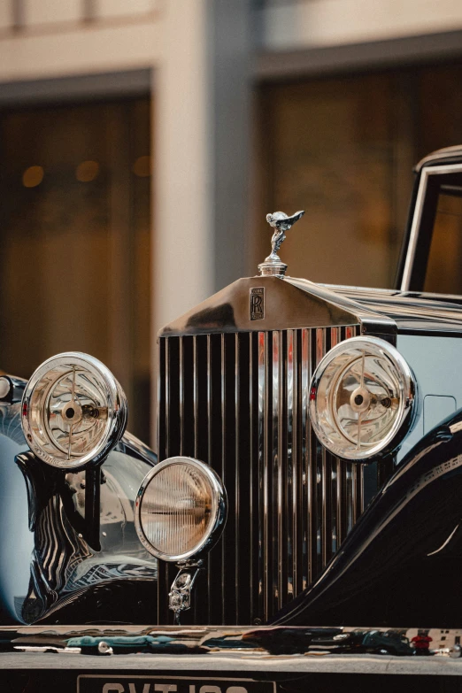 vintage car with chrome grille and hood vents and mirrors