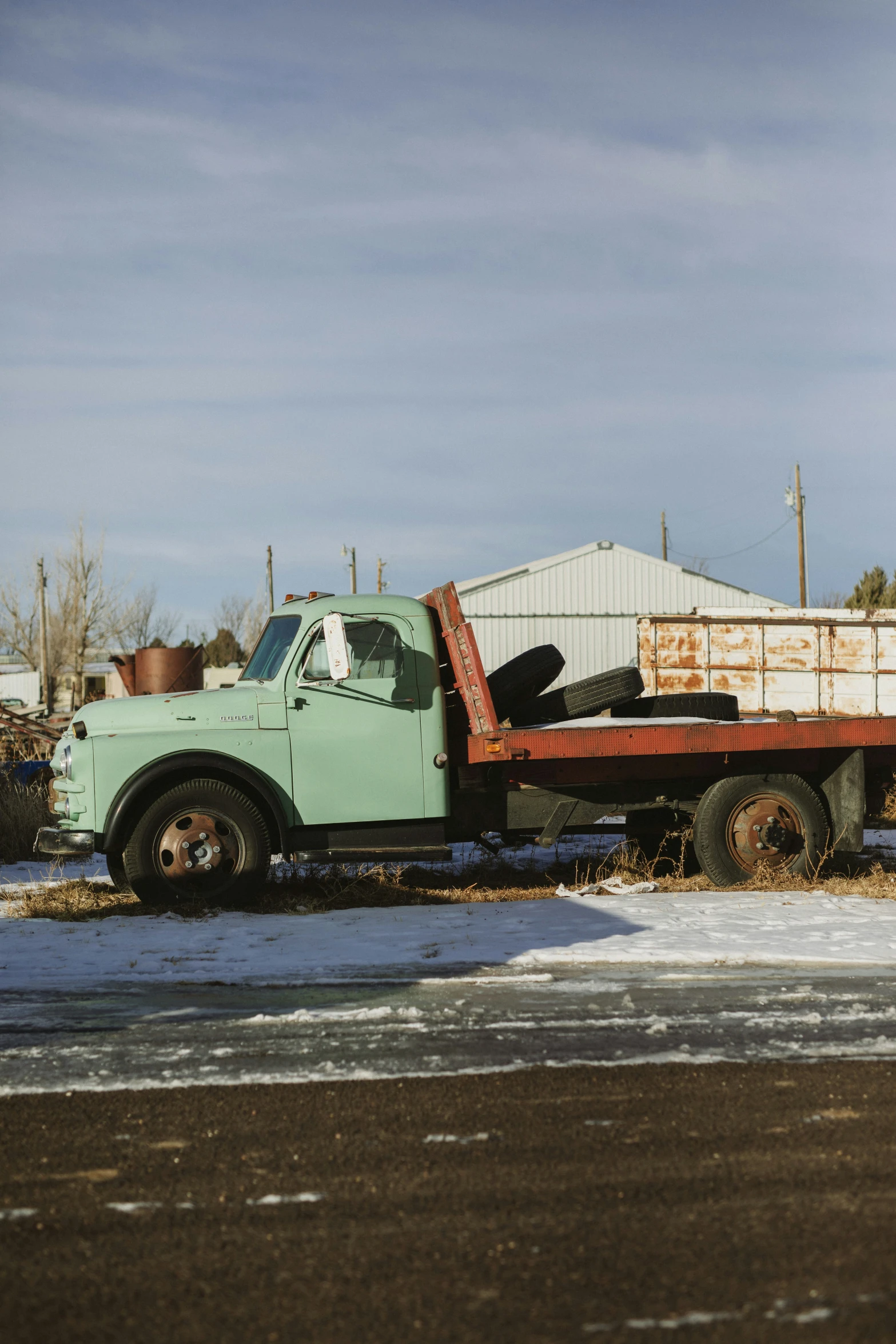 a pick up truck driving through snow covered roads