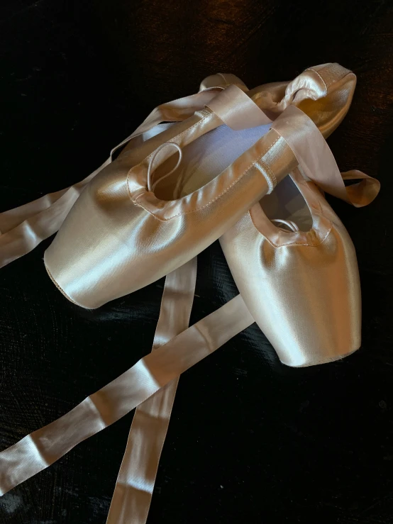 a pair of ballet shoes with satin ribbons