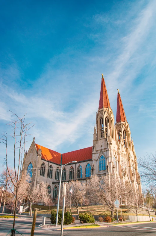 large church with a tower on top sits alone on a street