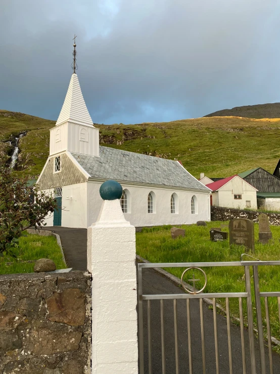 a church on the top of the hill with a fence around it