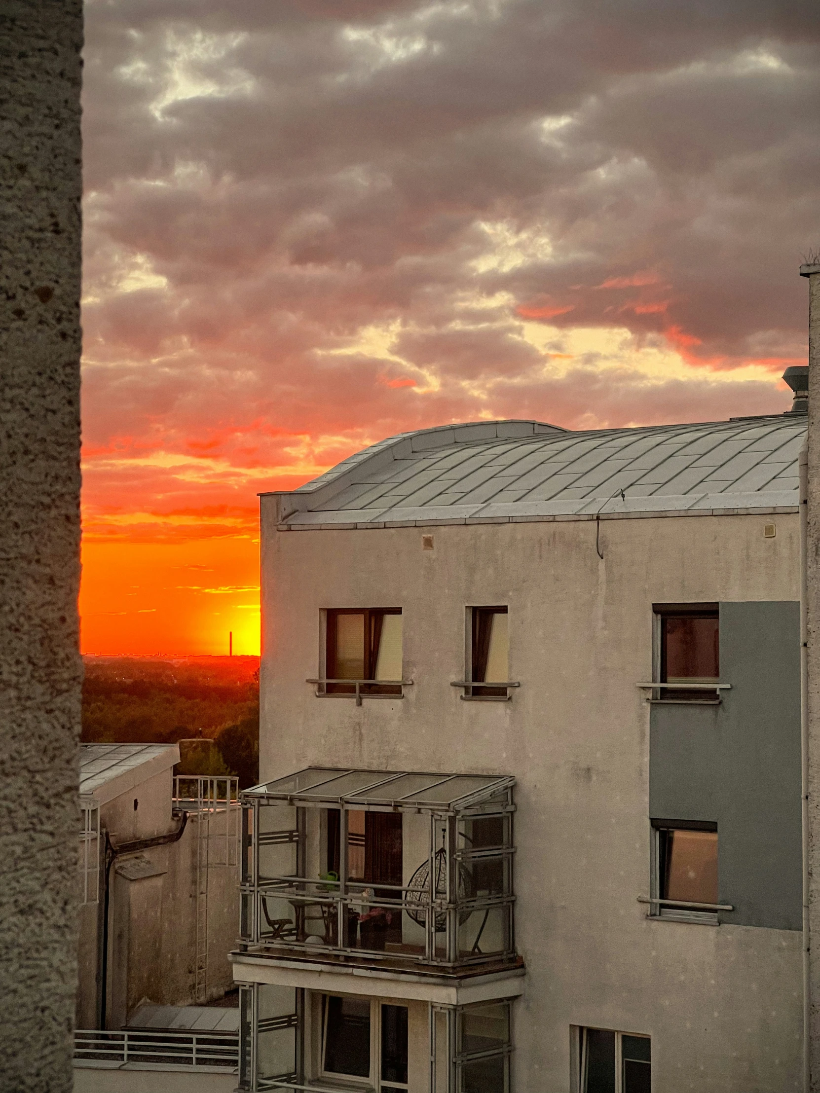 a view of a building with its balcony open at dusk