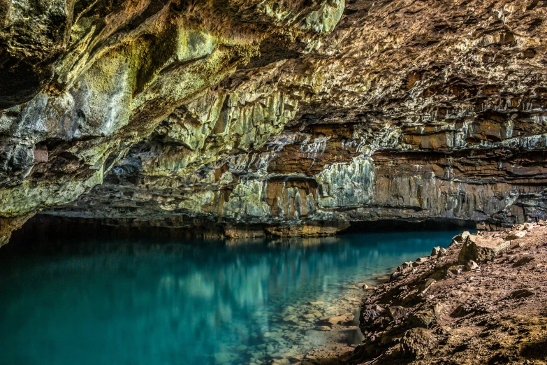 a man and a boy sitting at the edge of a cave