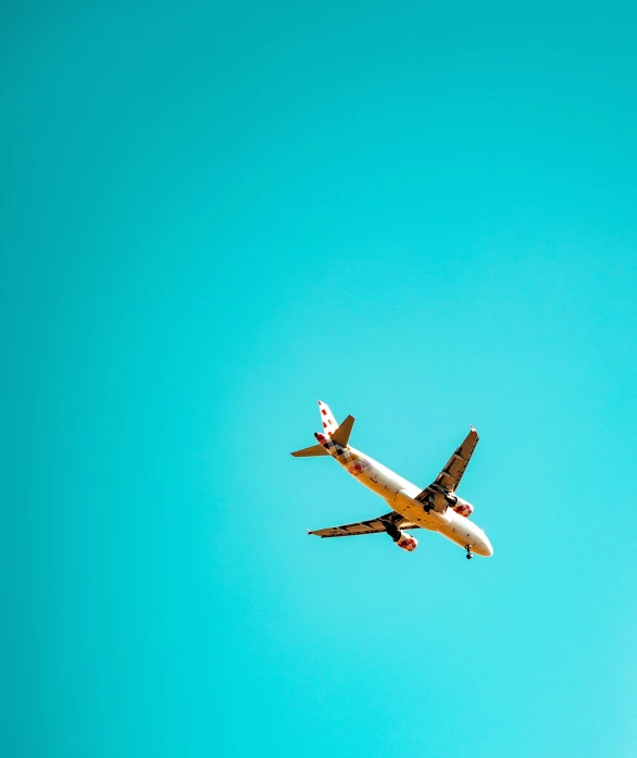 an air plane is flying in the clear blue sky