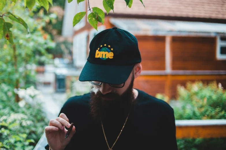 a man wearing a hat is smoking a cigarette