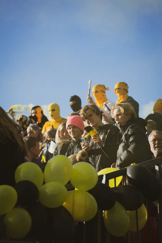 a group of people standing next to each other in front of a crowd