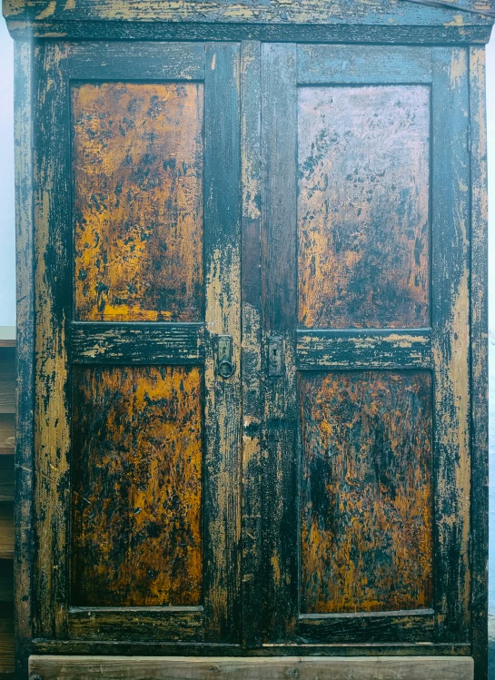 old worn paint covers wooden doors with rusty rust