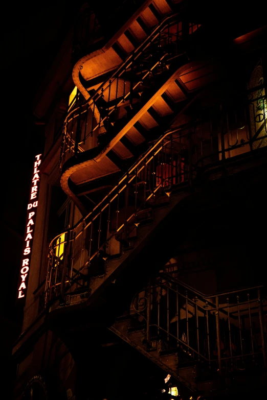 the stairs on the side of a building at night