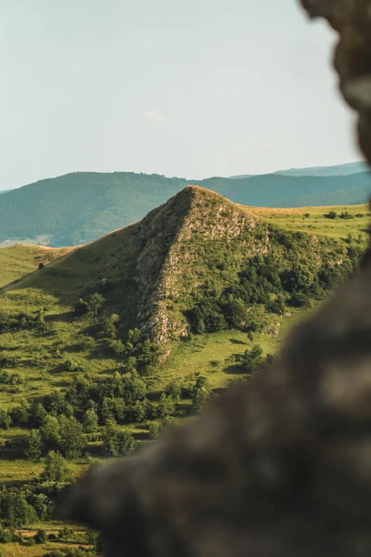 a couple of large mounds sitting on top of a grass covered field