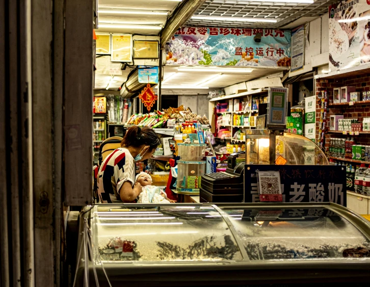 a person standing in a store with a fish display