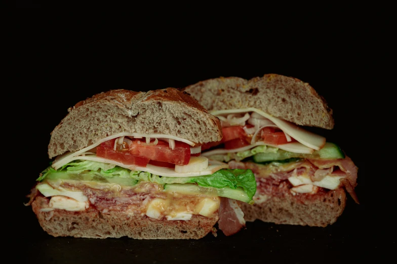 a black table with sandwiches on it and salads