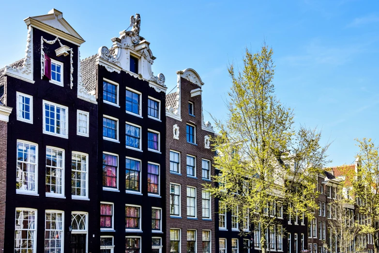 a group of buildings sitting along side of a sidewalk