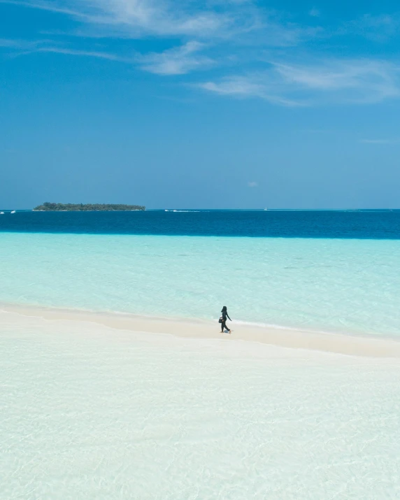 a lone man standing on a deserted beach