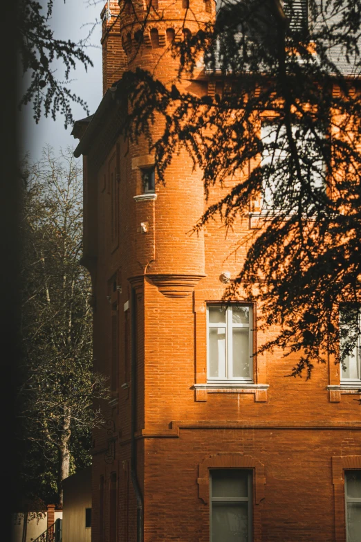 tall building with two story, brick walls and white windows