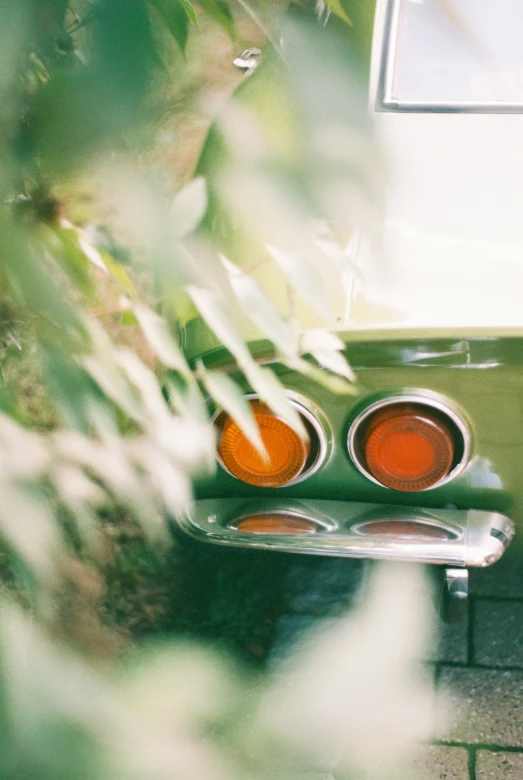 a vintage car sits parked in the shade