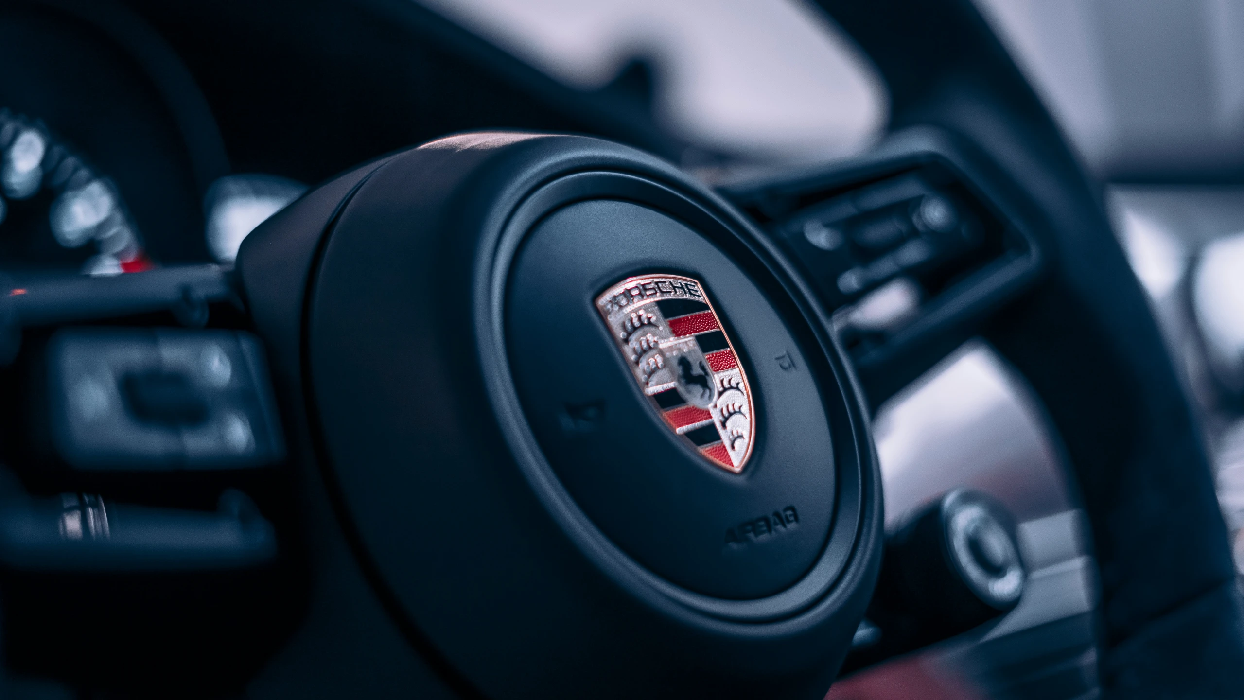 a close up s of the wheel and dashboard of an automobile