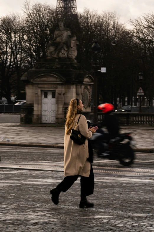 a woman is jogging and a red frisbee in the air