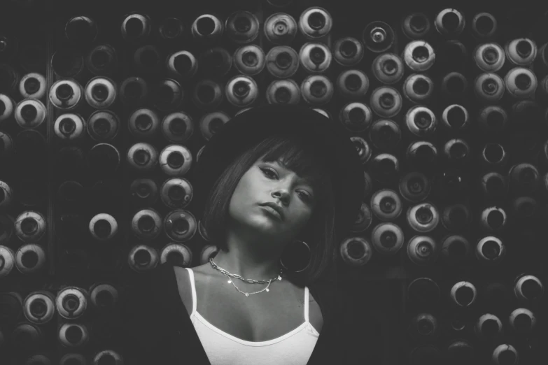 a woman poses against a wall of circles