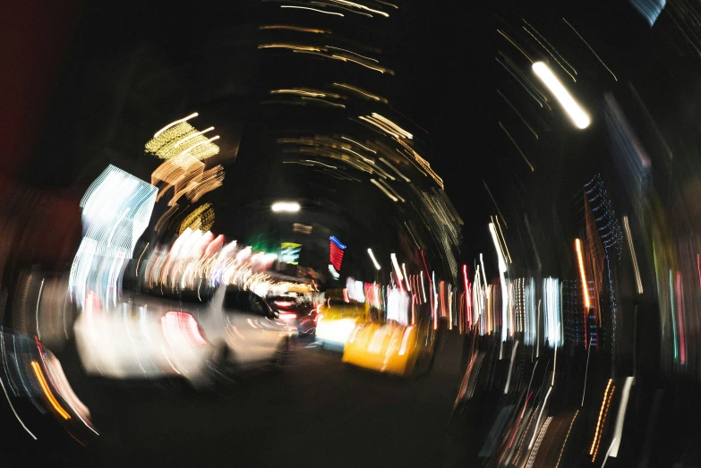 blurry image of cars at night with lights on them