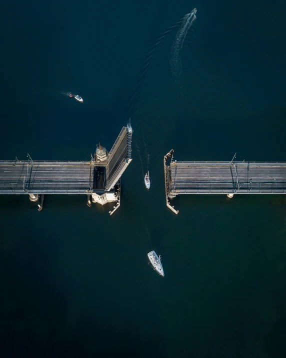 a large boat floating near a very tall bridge