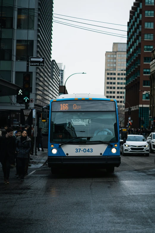 a bus drives down the street in the rain