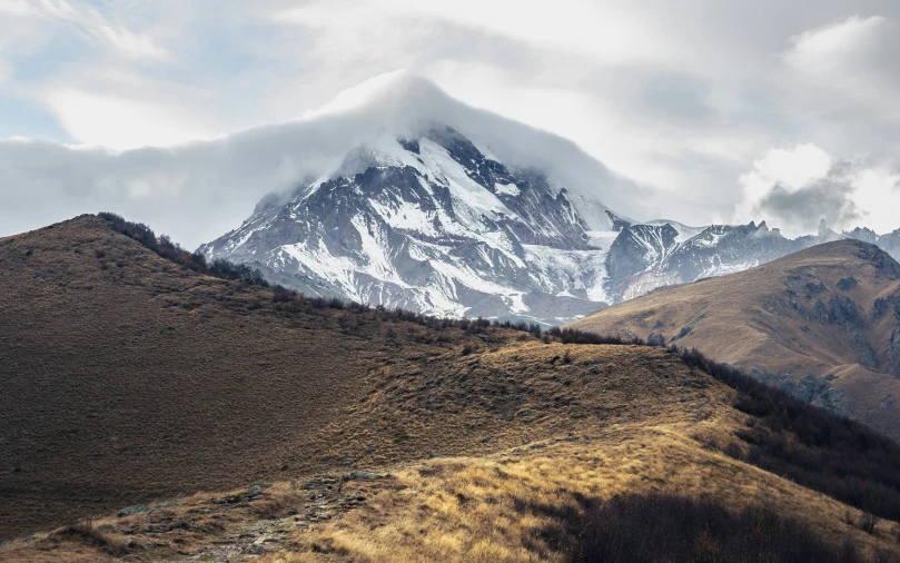 a view of a very tall mountain that is covered in snow