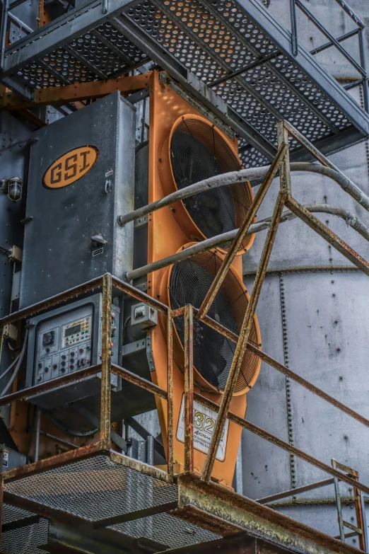 two giant orange street lights attached to some metal structures