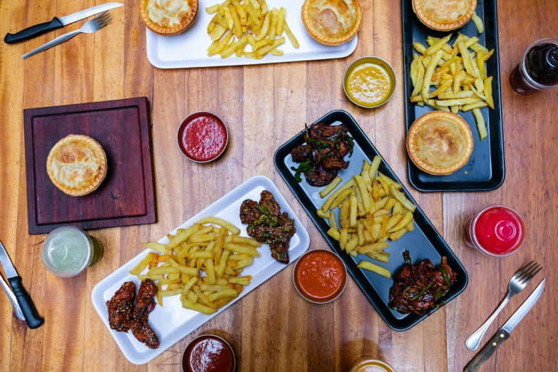 two trays on the table with several kinds of food